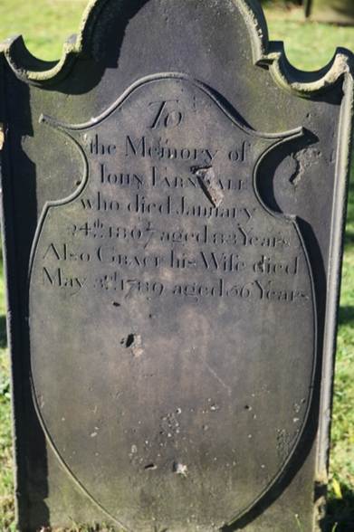 A tombstone with engraved text

Description automatically generated